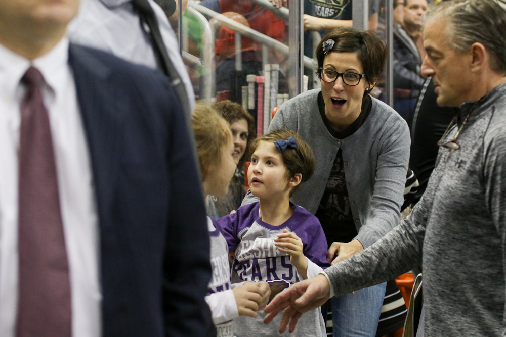 Kennedy Stevenson, Center, Looks Up Into The Stands As Her Mother Walks With Her Onto The Hershey Bears Bench.