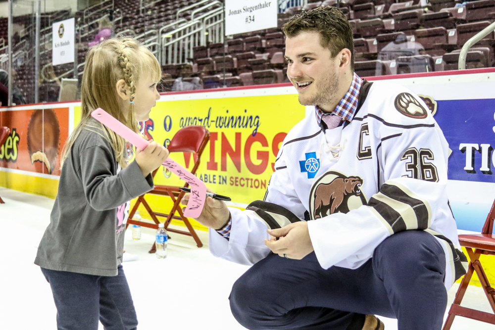 Garrett Mitchell Hands A Pink Stick Back To A Young Fan