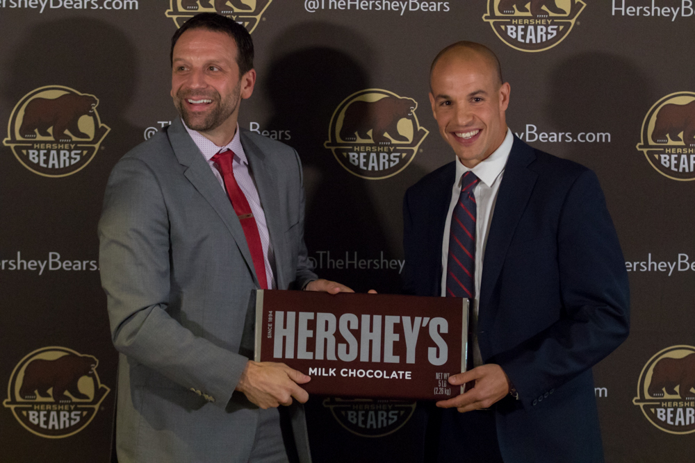 Bryan Helmer Presents Spencer Carbery With A Five Pound Chocolate Bar.